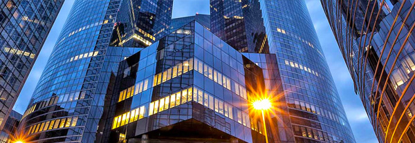 A brightly illuminated building at night, with sunlight casting a warm glow on its facade.