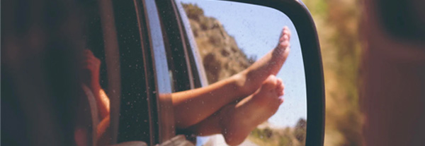 A close-up captures a family in a car on the road, enjoying their journey together.